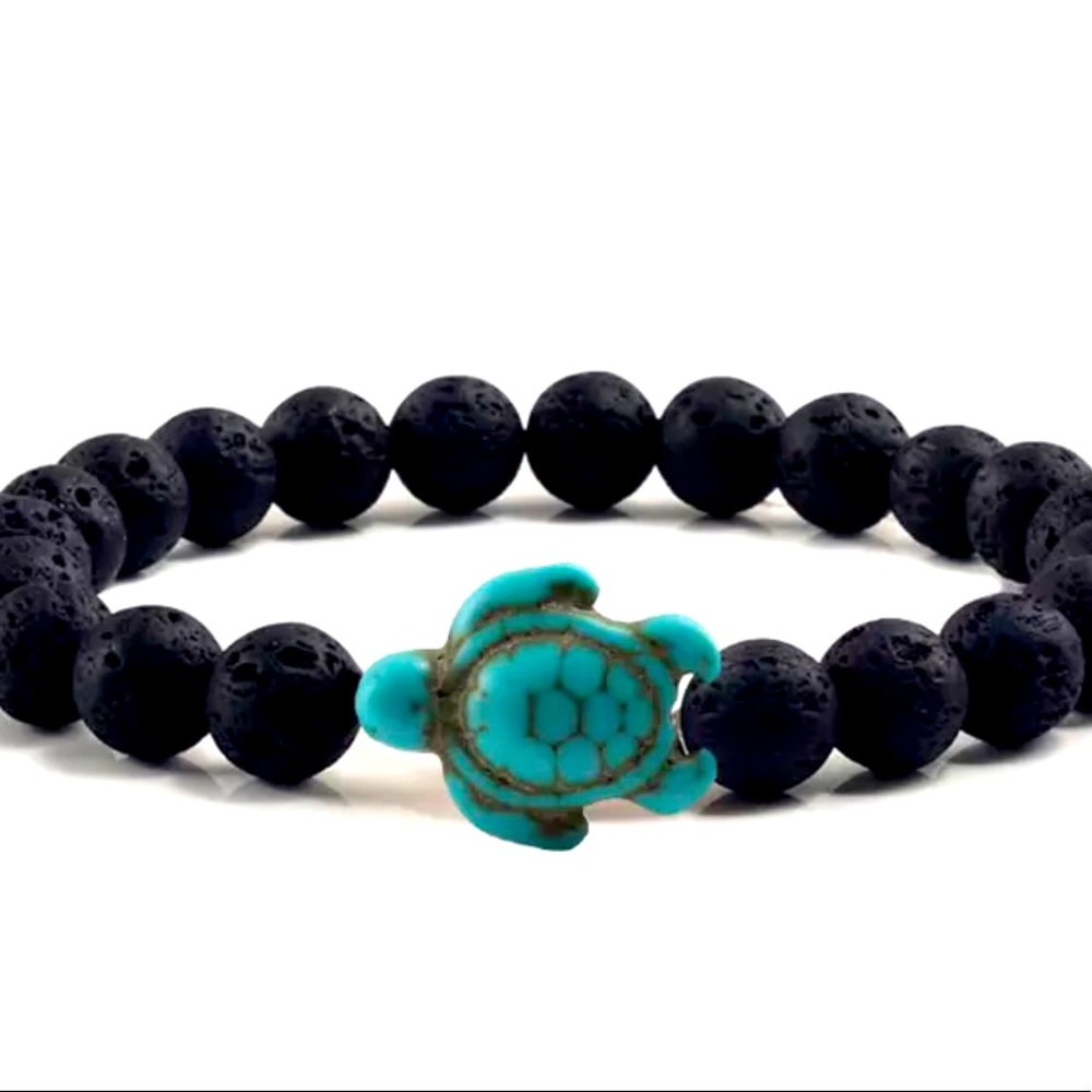 Black lava stones with turquoise sea turtle charm